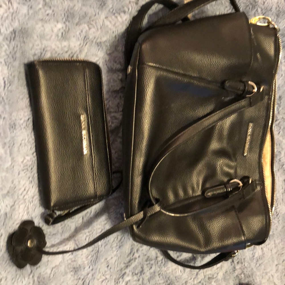 ￼Dana Buchma black bag With matching wallet used very little .